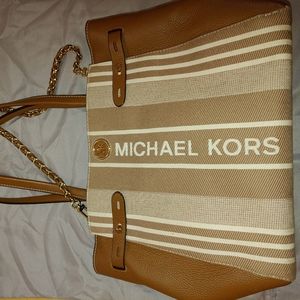Michael kors brown with logo purse. Small damage on bottom.